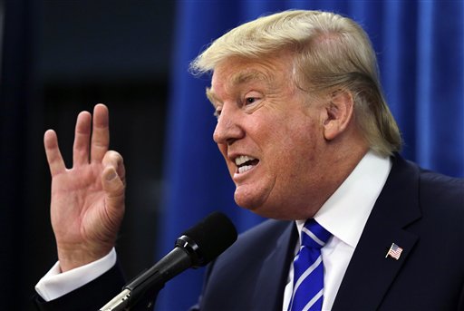 Republican presidential candidate Donald Trump gestures during a media availability prior to a campaign stop at Winnacunnet High School in Hampton N.H. Trump sells himself as a bold empire builder the kind of risk taker who