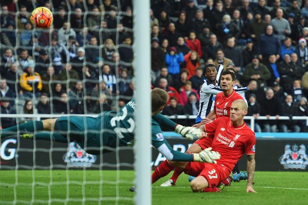 Martin Skrtel of Liverpool deflects a cross from Georginio Wijnaldum of Newcastle United past goalkeeper Simon Mignolet of Liverpool for an own goal and Newcastle's first during the Barclays Premier League match between Newcastle United and