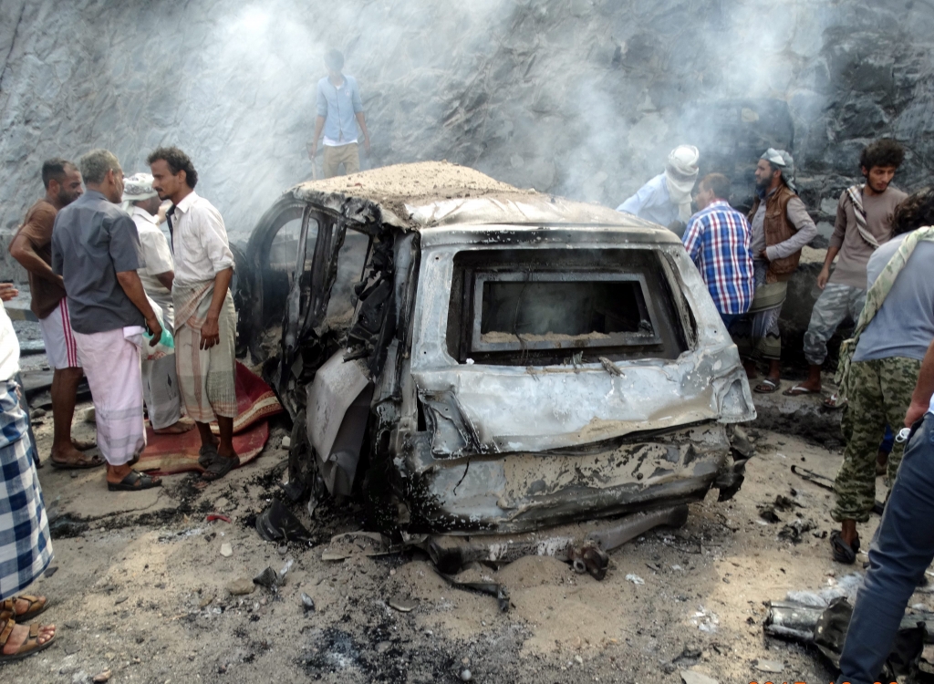 Yemenis inspect the scene of a car bomb attack that killed a Yemeni senior official in the southern port city of Aden Yemen on Sunday