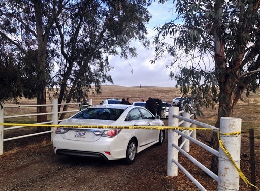 Kern County Sheriffs officials and deputies gather at the scene where a medical helicopter crashed near McFarland Calif. Friday Dec. 11 2015. The medical helicopter carrying a patient to a hospital crashed amid heavy rain and fog in a rural area of