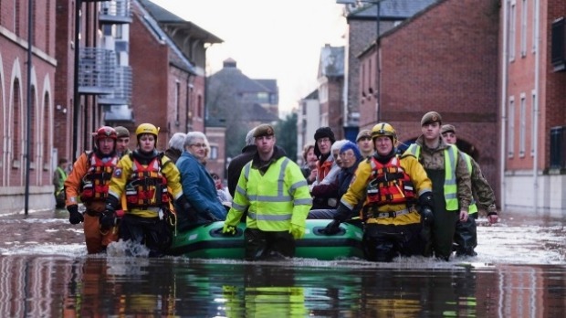 Rescuers and soldiers assist members of the public as they are evacuated from the Queens Hotel in York city centre as the River Ouse floods