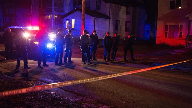 Police line up in front of a crime scene after 5 people were shot at a Black Lives Matters protest