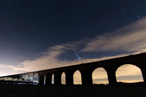 A meteor passes over the Harringworth viaduct in Northamptonshire during the Geminids meteor shower last December
Corbis