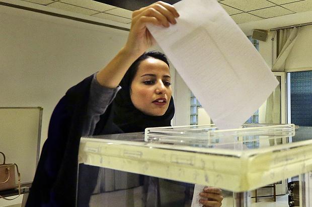 A Saudi woman casts her ballot at a polling center during municipal elections in Riyadh Saudi Arabia