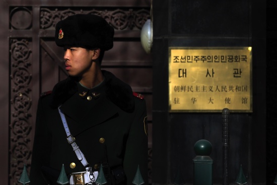 A Chinese paramilitary policeman stands guard outside the North Korean Embassy in Beijing