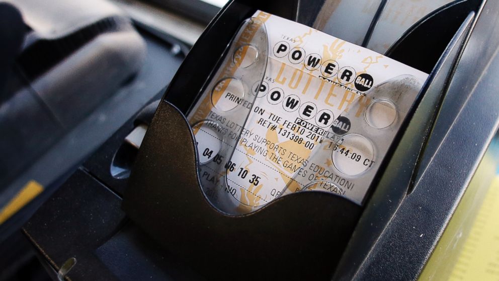 A Powerball ticket sits in the tray dispenser after being printed out for a customer at Fuel City in Dallas Feb. 10 2015. | AP