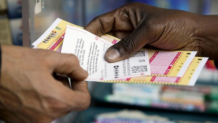 A man receives his tickets in Wednesday's $1.5 billion Powerball lottery