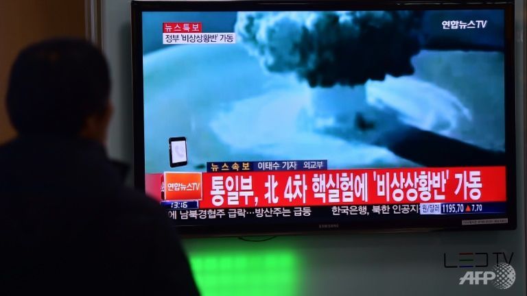 A man watches a news report on North Korea's first hydrogen bomb test at a railroad station in Seoul