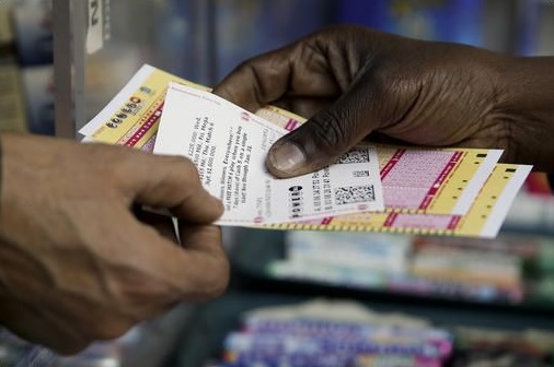 A person purchases Powerball lottery tickets from a newsstand Wednesday Jan. 6 2016 in Philadelphia