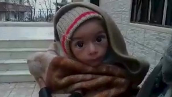 A toddler is held up to the camera in this still image taken from video said to be shot in Madaya on Jan. 5 2016