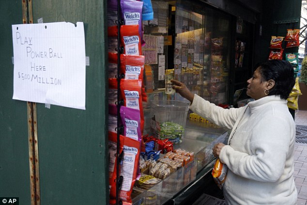 A woman purchase Powerball lottery tickets from a newsstand in Philadelphia