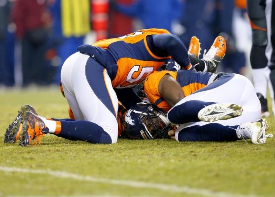 Denver Broncos outside linebacker De Marcus Ware right lies