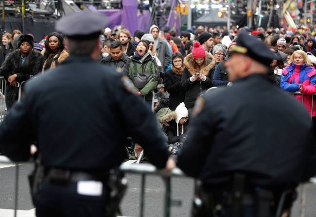 Police officers look over a crowd waiting for midnight in Times Square in New York Thursday Dec. 31 2015