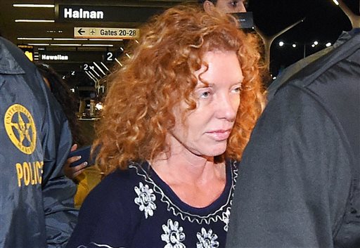 Tonya Couch center is taken by authorities to a waiting car after arriving at Los Angeles International Airport Thursday Dec. 31 2015 in Los Angeles. Authorities said she and her son Texas teenager Ethan Couch who was sentenced to probation after