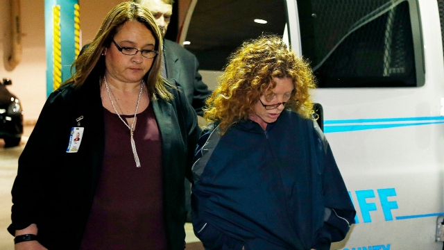 Tonya Couch is escorted by a sheriffs deputy as she arrives at the Tarrant County Jail in Fort Worth Texas