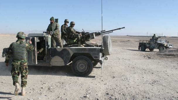 Afghan National Army soldiers guard at a checkpoint on the way to the Sangin district of Helmand province