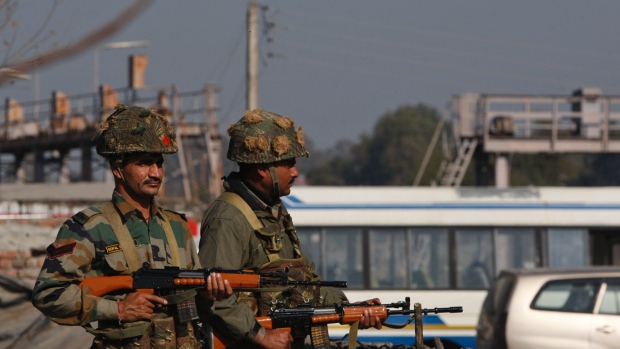 Indian army soldiers take positions outside the Indian airbase in Pathankot 430 kilometres north of New Delhi India on Saturday Jan. 2 2016. At least four gunmen entered an Indian air force base near the border with Pakistan on Saturday morning and