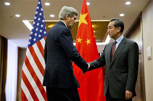 U.S. Secretary of State John Kerry left shakes hands with Chinese Foreign Minister Wang Yi ahead of their meeting at the Ministry of Foreign Affairs in Beijing Wednesday Jan. 27 2016 on the final leg of the secretary's latest round-the-world diploma