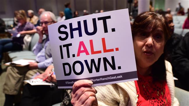 A local protester holds a placard expressing her feelings as residents from Porter Ranch and neighboring communities attend a town hall meeting at the Shepard of the Hills Church in Porter Ranch California