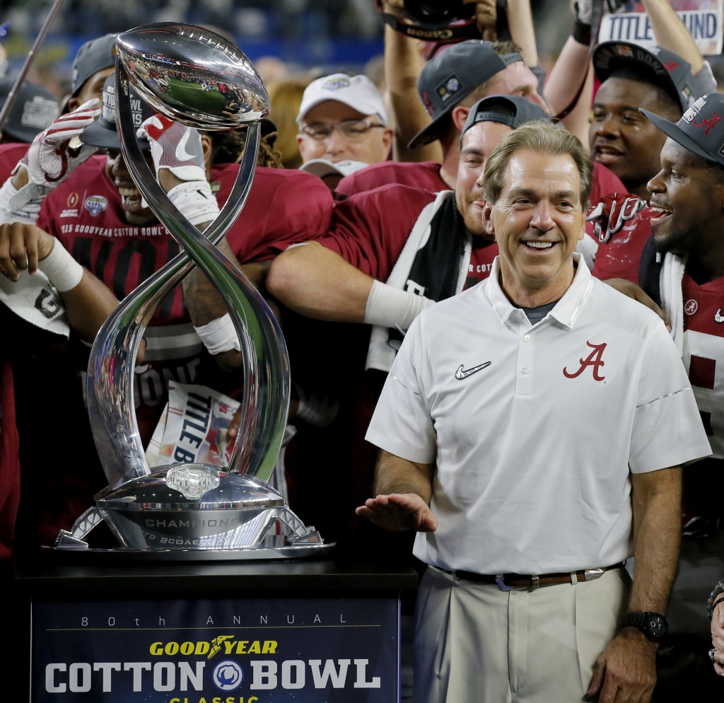 Alabama coach Nick Saban pauses next to the Field Scovell Trophy after his team's Cotton Bowl semifinal playoff game against Michigan State Thursday night in Arlington Texas. Alabama won 38-0 to advance to the national championship game