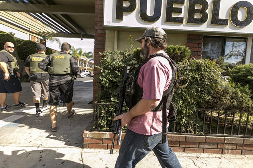 Orange County Sheriff agents search the back of a hotel for escaped inmates in Santa Ana Calif. on Friday Jan. 29 2016. Authorities say they have captured one of three inmates who escaped from a California jail last week while facing charges involving