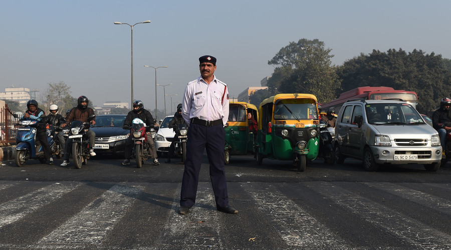 An India traffic policeman stands at a traffic intersection in New Delhi