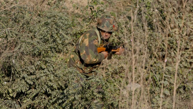 An Indian army soldier is seen search a forest area outside the Pathankot air force base on Sunday