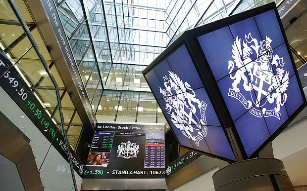 An information screen displaying the FTSE 100 which has risen above 7,000 mark for the first time and hit a new record high at the London Stock Exchange in Paternoster Square London Friday