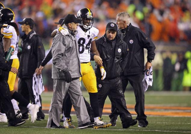 Antonio Brown is helped off the field after taking a hit to the head from Vontaze Burfict