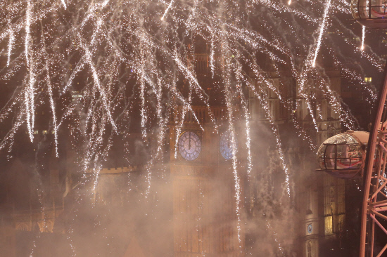 Fireworks explode around The Elizabeth Tower also known as'Big Ben and the London Eye during New Year's celebrations in central London just after midnight on Jan 1 2016. AFP