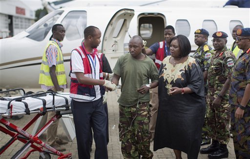 A Kenyan soldier center who Kenya Defence Forces said was injured in the attack by al Shabab in Somalia earlier this week is assisted by Cabinet Secretary for Defence Raychelle Omamo center-right as he walks with a drip after being airlifted back