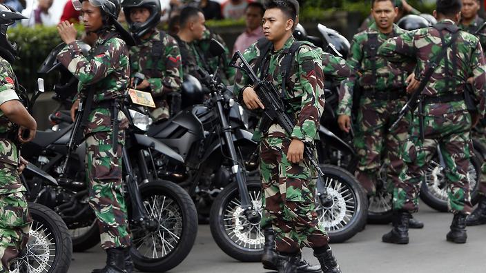 Armed Indonesian soldiers stand guard after gunfire and bomb blasts in front of a shopping mall in Jakarta Indonesia 14 January 2016