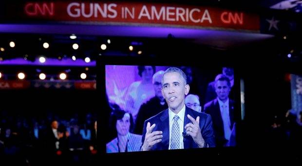 U.S. President Barack Obama is seen on a monitor as he speaks during a live town hall event on reducing gun violence hosted by CNNÄôs Anderson Cooper at George Mason University in Fairfax Virginia