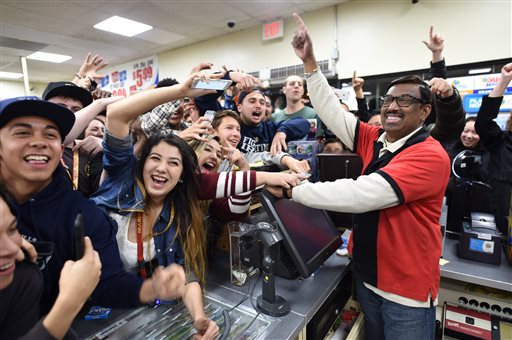 7-Eleven store clerk M. Faroqui celebrates with customers after learning the store sold the only winning Powerball ticket on Wednesday Jan. 13 2016 in Chino Hills Calif. One winning ticket was sold at the store located in suburban Los Angeles said Alex