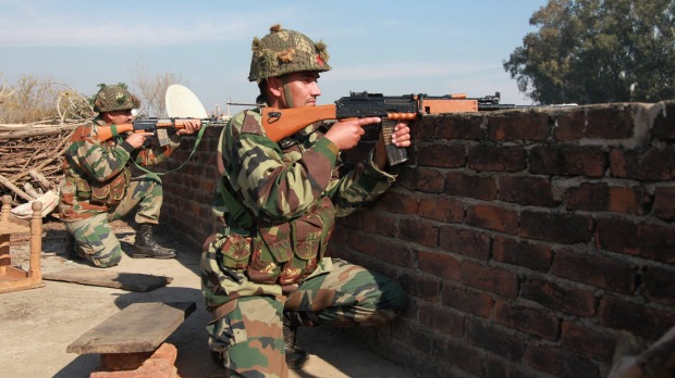 Attacked Indian army soldiers take positions on a rooftop outside the Pathankot air base