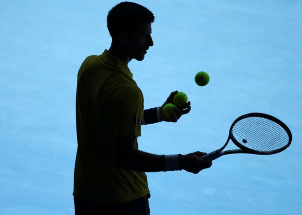 Novak Djokovic of Serbia prepares to serve to Gilles Simon of France during their fourth round match at the Australian Ope