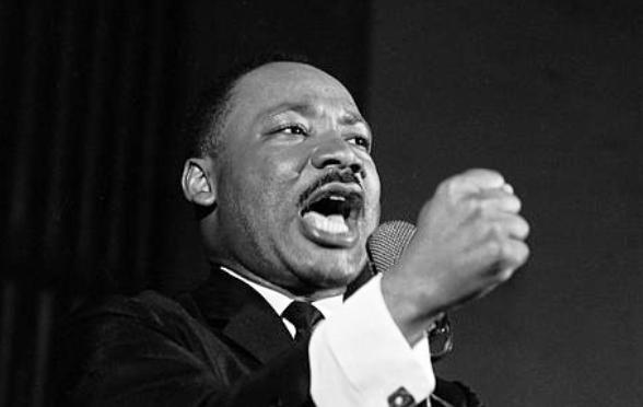 Dr. Martin Luther King Jr. shakes his fist during a speech in Selma Ala. Feb. 12 1965. King was engaged in a battle with Sheriff Jim Clark over voting rights and voter registration in Selma