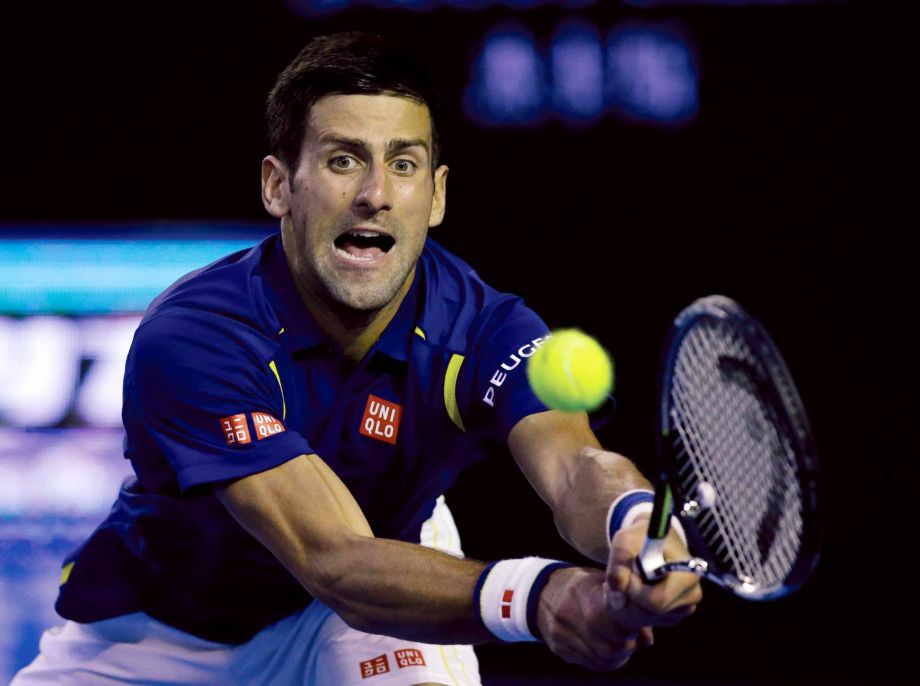 Novak Djokovic of Serbia plays a backhand return to Roger Federer of Switzerland during their semifinal match at the Australian Open tennis championships in Melbourne Australia Thursday Jan. 28 2016