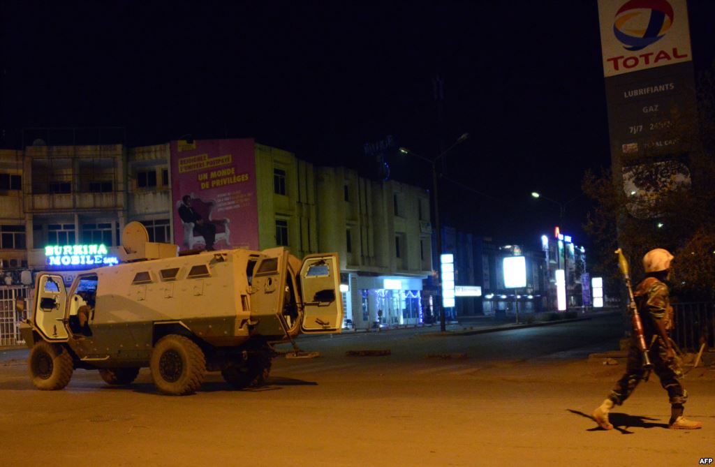 Army forces drive near the Splendid Hotel in Burkina Faso's capital Ouagadougou after gunmen stormed the hotel and took several hostages Jan. 15 2016