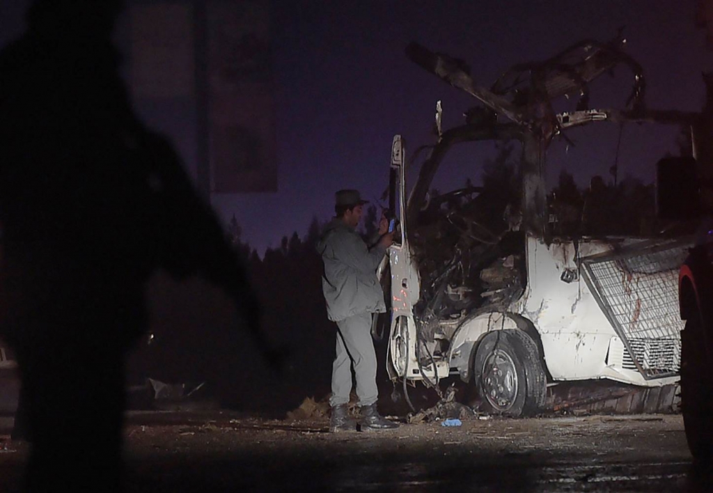 Image Image A policeman inspects a bombed bus