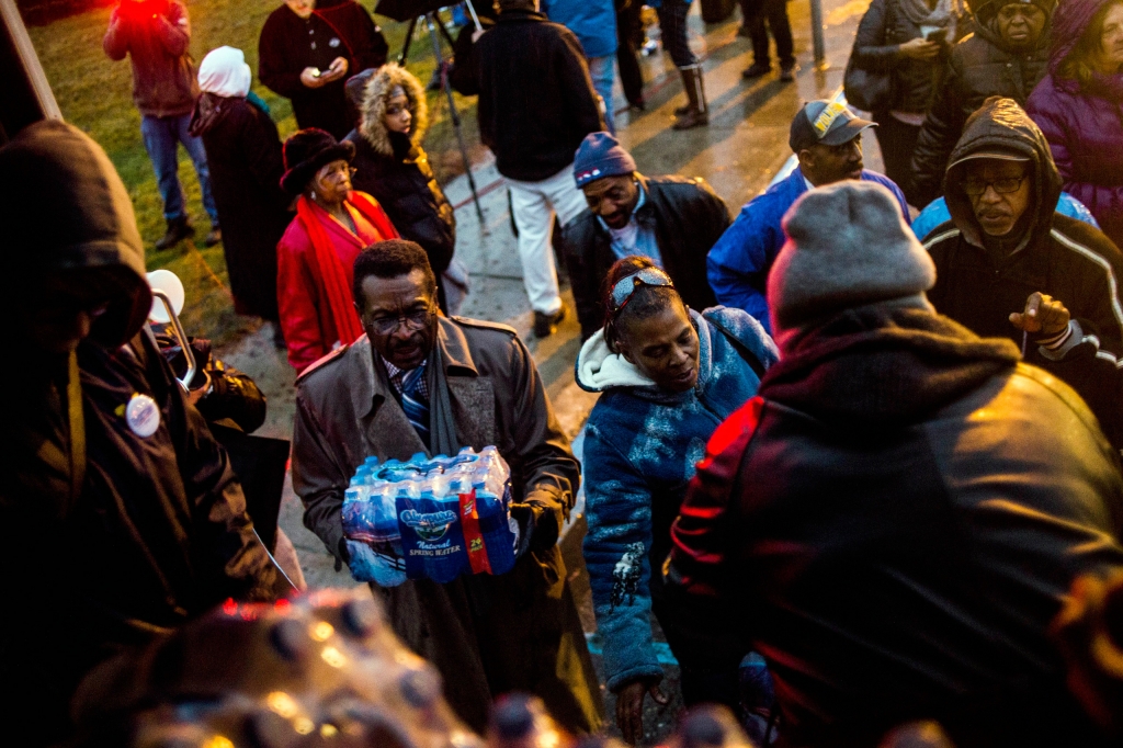 Flint residents line up for free bottled water as activists protest outside of City Hall to protest Michigan Gov. Rick Snyder's handling of the water crisis Friday Jan. 8 2016 in Flint. Mich. LOCAL TELEVISIO