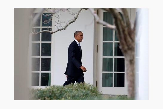 President Barack Obama walks along the colonnade of the White House in Washington Tuesday Jan. 12 2016 to the residence from the Oval Office hours before giving his State Of The Union address