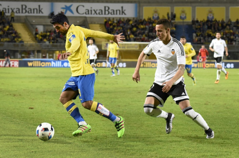 AFP  Desiree MartinValencia's forward Rodrigo runs from Las Palmas&#039 midfielder Emmanuel Culio during the Spanish Copa del Rey football match at the Estadio de Gran Canaria in Las Palmas de Gran Canaria