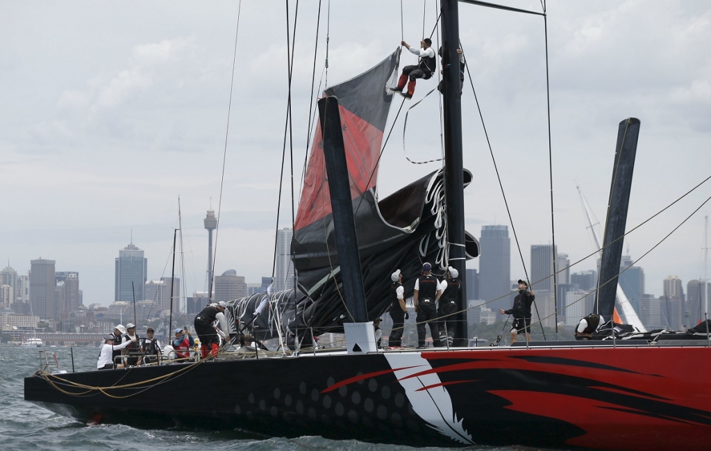 Crew members aboard the Maxi yacht Comanche work on the main mast during preparations for the start of the 71st Sydney to Hobart Yacht race Australia's premiere bluewater classic race yesterday. – Reuters pic