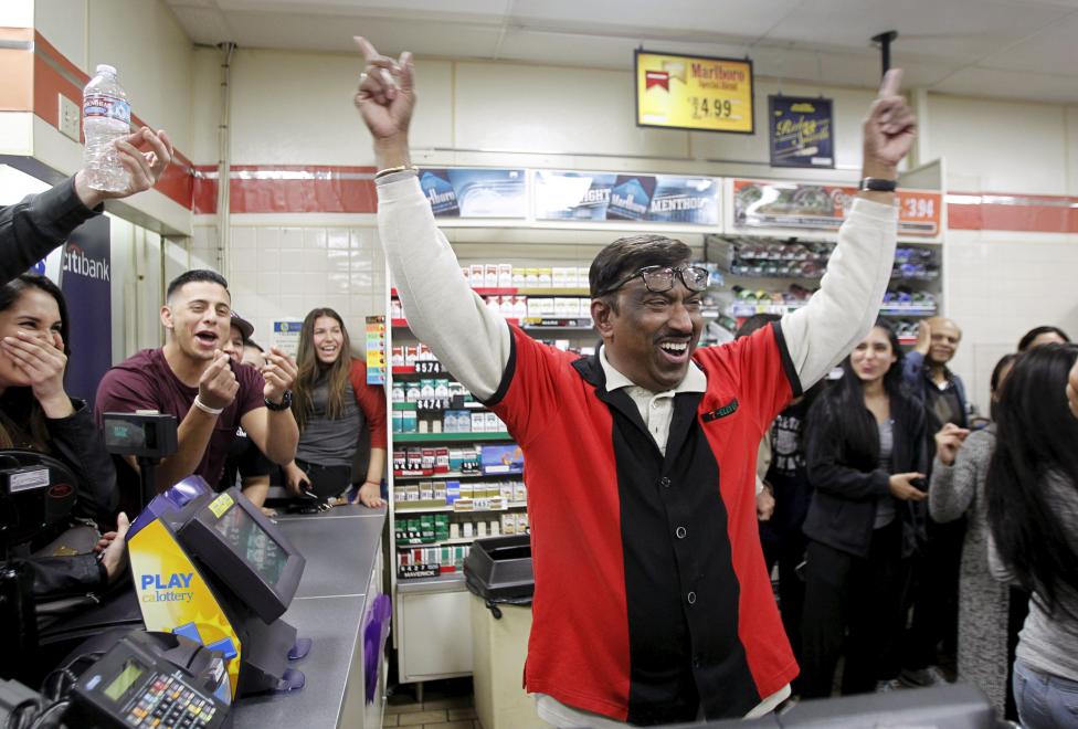 7-Eleven store clerk M. Faroqui celebrates after selling a winning Powerball ticket was sold is shown in Chino Hills California