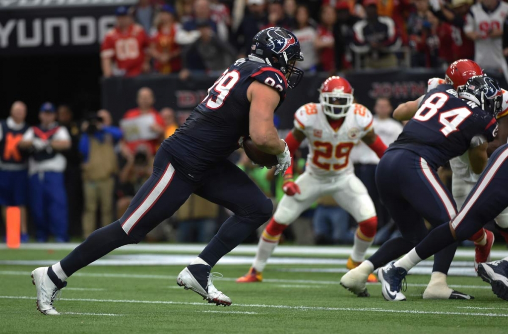 Houston Texans defensive end J.J. Watt carries the ball on offense against the Kansas City Chiefs during the first half of an NFL wild-card playoff football game Saturday Jan. 9 2016 in Houston