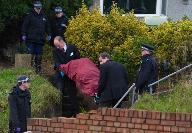 Police remove a body from the onetime London home of'EastEnders actress Sian Blake on Tuesday