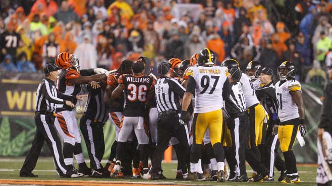 Officials step in between players from Cincinnati Bengals and Pittsburgh Steelers during the second half of an NFL wild-card playoff football game Saturday Jan. 9 2016 in Cincinnati