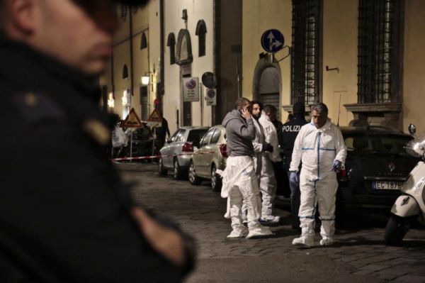 Italian forensic police officers stand outside an apartment