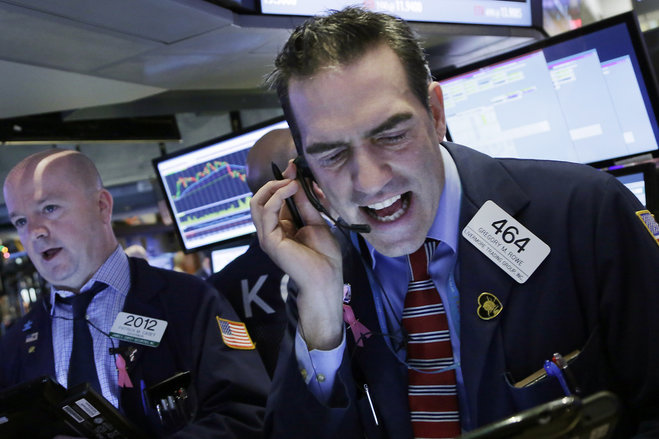 Stock trader Gregory Rowe works at the New York Stock Exchange Friday Jan. 15 2016